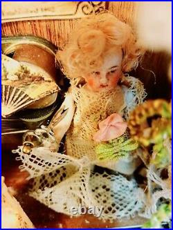 Antique mechanical 3 inch German doll her arm moves with scissors
